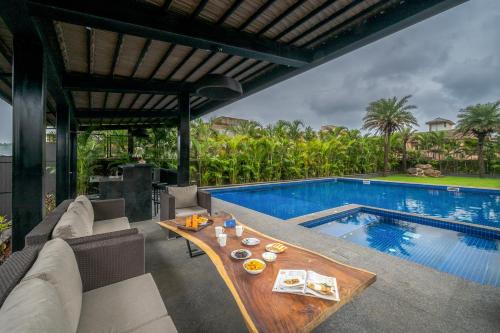 Kune N.m. Villa | SaffronStays Three Palm Villa -7-BR villa with pool, jacuzzi, gazebo bar & lawns for celebrations in Lonavala
